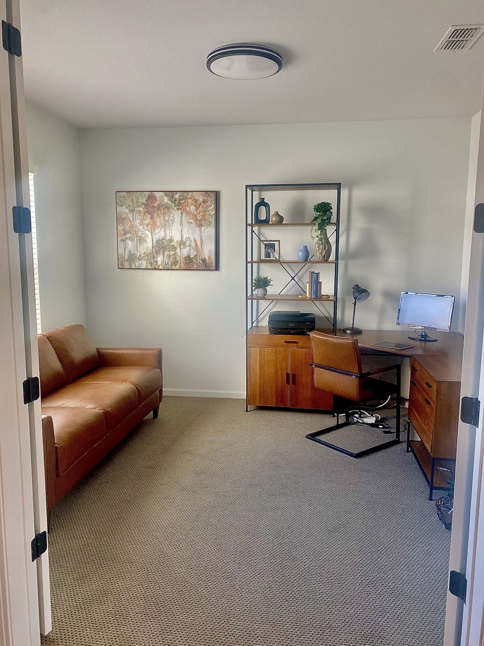 Office has a very large desk, an Italian leather couch and doors that close 
