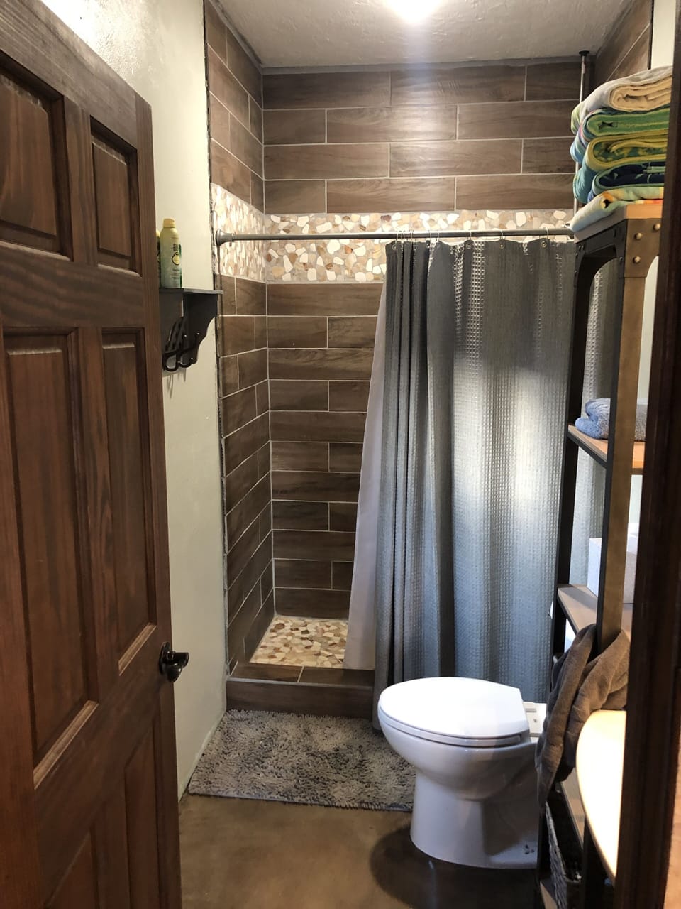 spacious master bath with large custom tile shower with removable shower head 