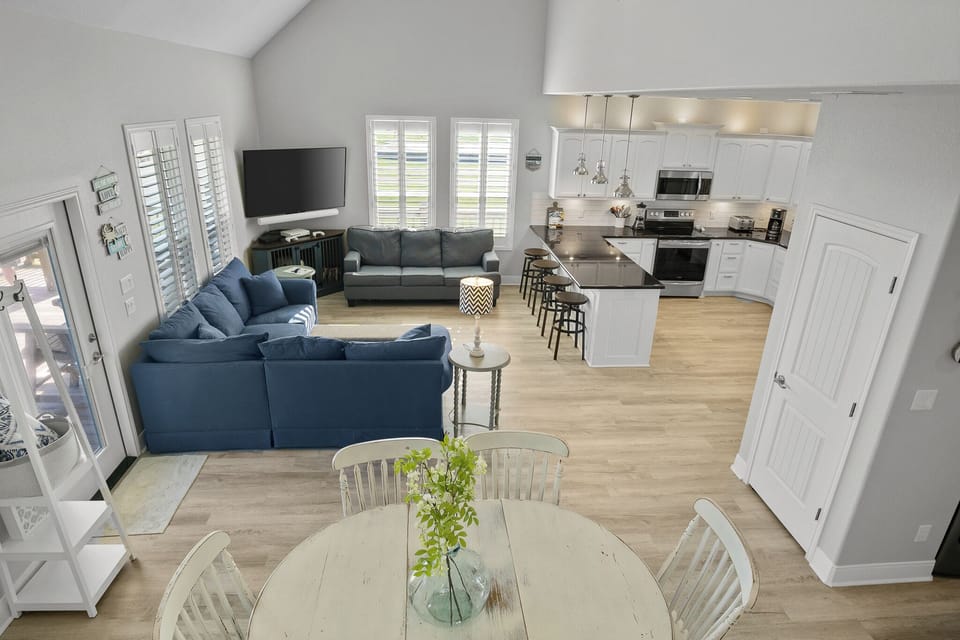 View of the living room and kitchen from the stairs.