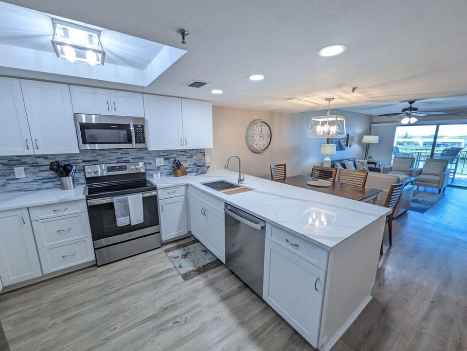 Well-equipped kitchen w/ ample counter space, modern appliances, & room to prep together.