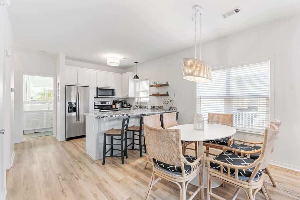 - Share meals & memories in this bright space featuring a granite island & cozy dining nook - Rattan chairs, pendant lighting, & soft wood floors bring warmth & style to every bite - Whether it's pancakes or game night, this spot is made for gatherin
