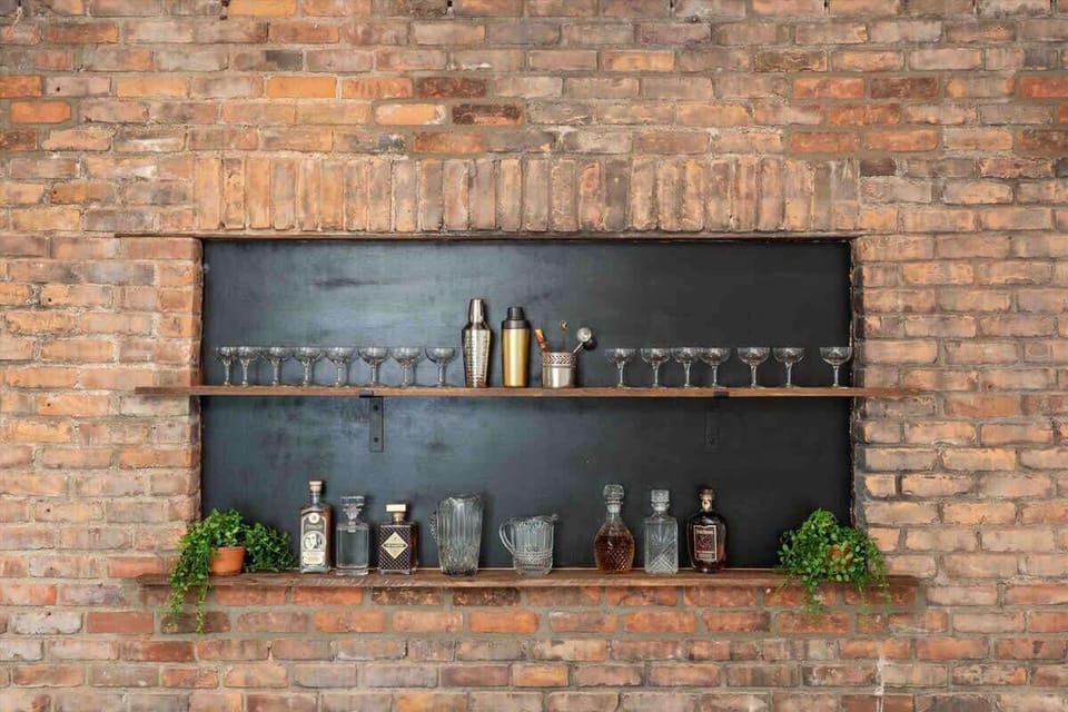Built-in brick bar nook with glassware display.