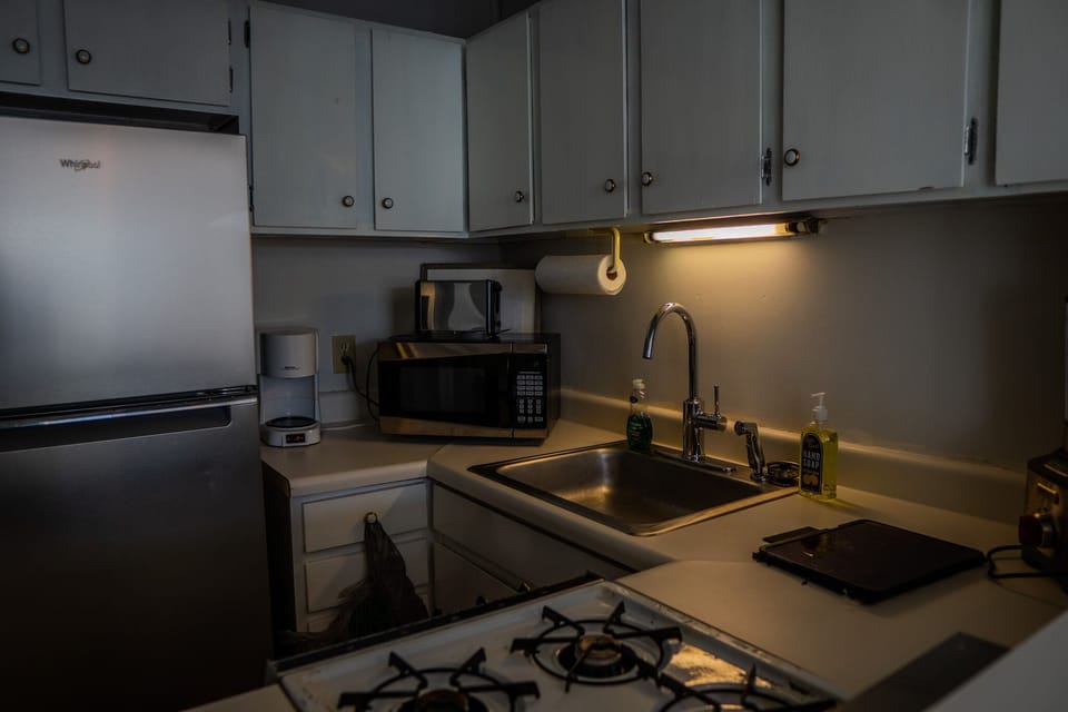Kitchenette equipped with cookware and appliances.