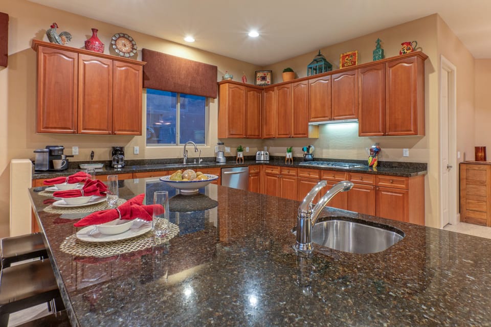 Modern kitchen has island seating and both Keurig and drip coffee makers.