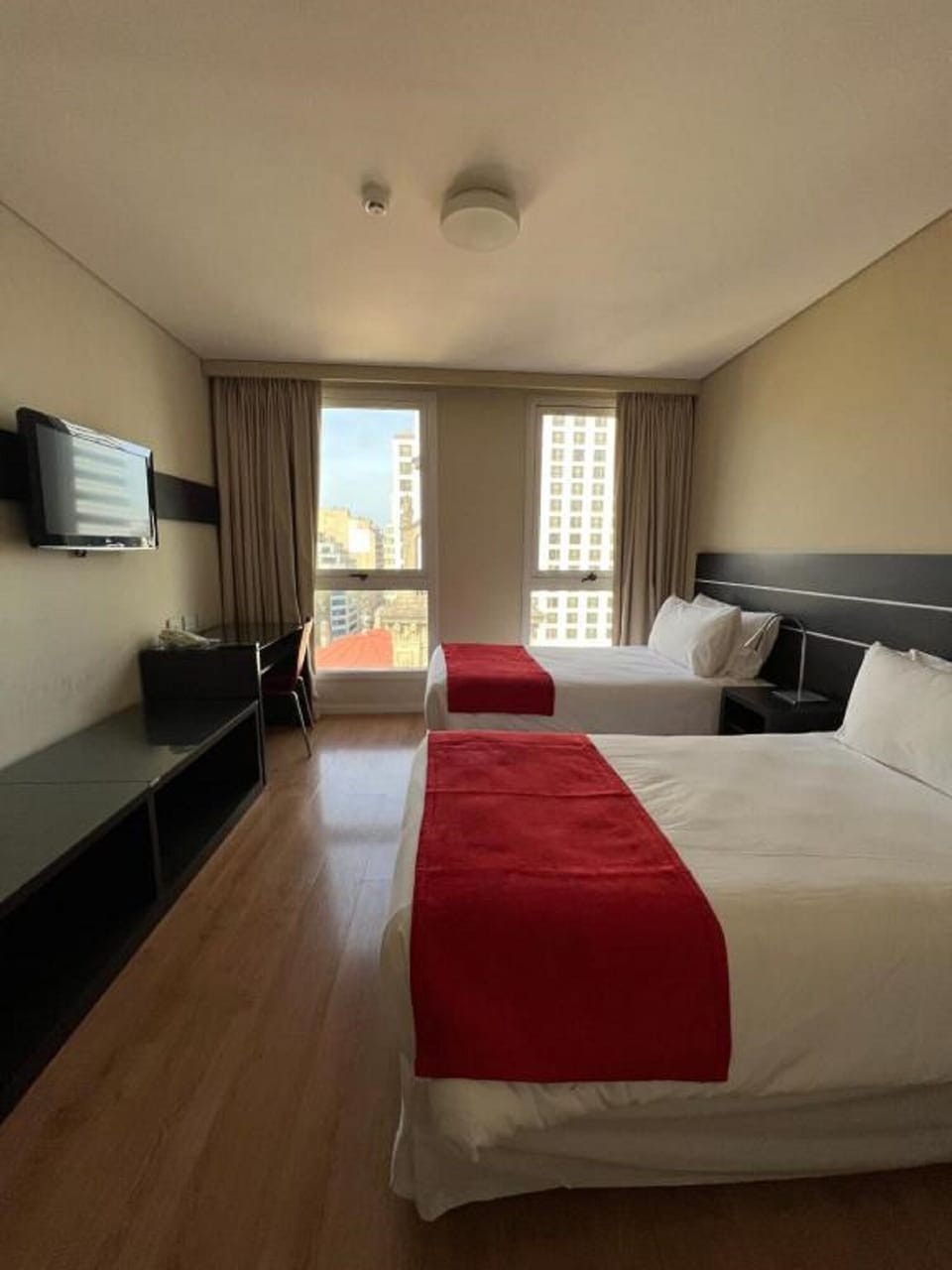 Wake up to city views from a calm, airy room.