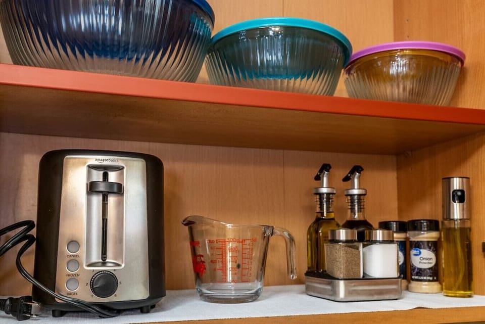 Stocked kitchen: oil, vinegar, salt/pepper, toaster, mixing bowls, etc.