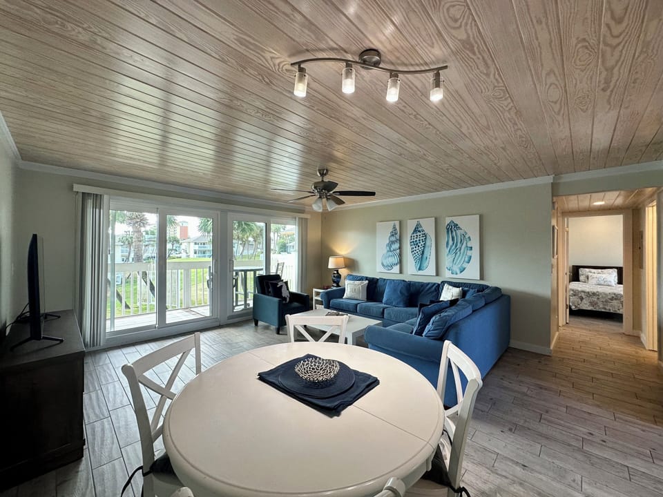 Unwind in your coastal living room where nautical artwork and plush navy seating create the perfect waterside retreat.