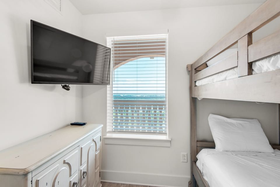Bunk room with flat screen TV