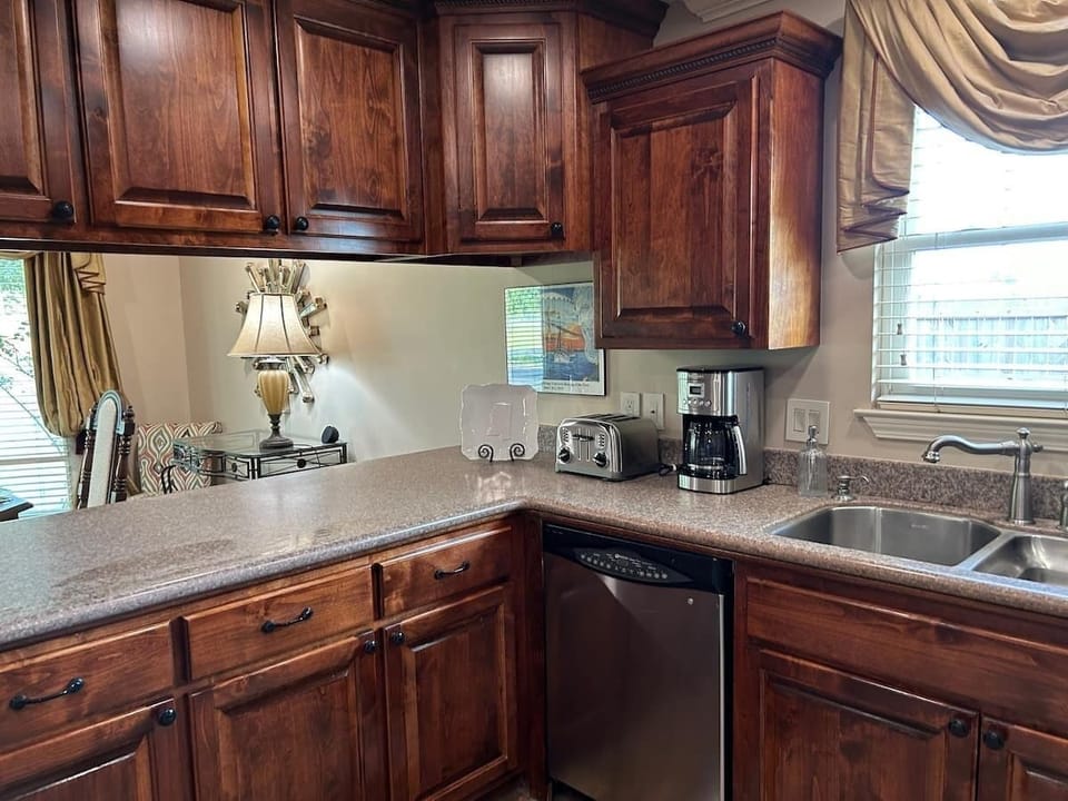 Large kitchen with dishwasher with view looking into dining room.