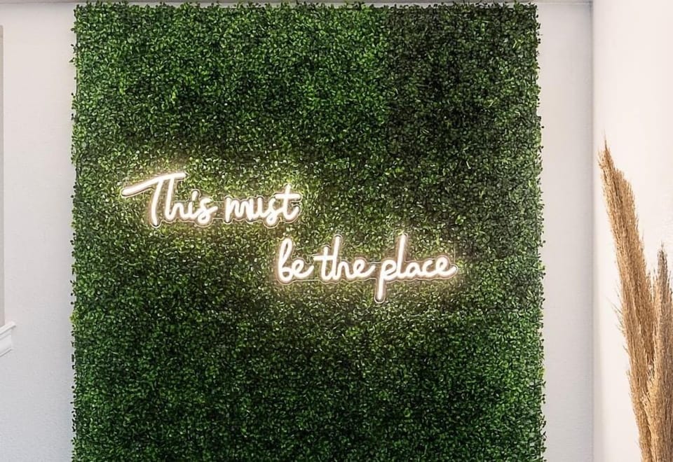 We customized a boxwood wall and neon sign for our guests to take pictures. The sign brightness can be adjusted to fit any type of camera. 