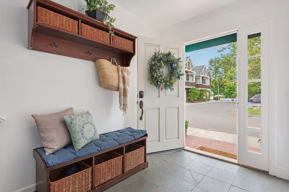 Entryway with stairs on the left, laundry and downstairs rooms on the right