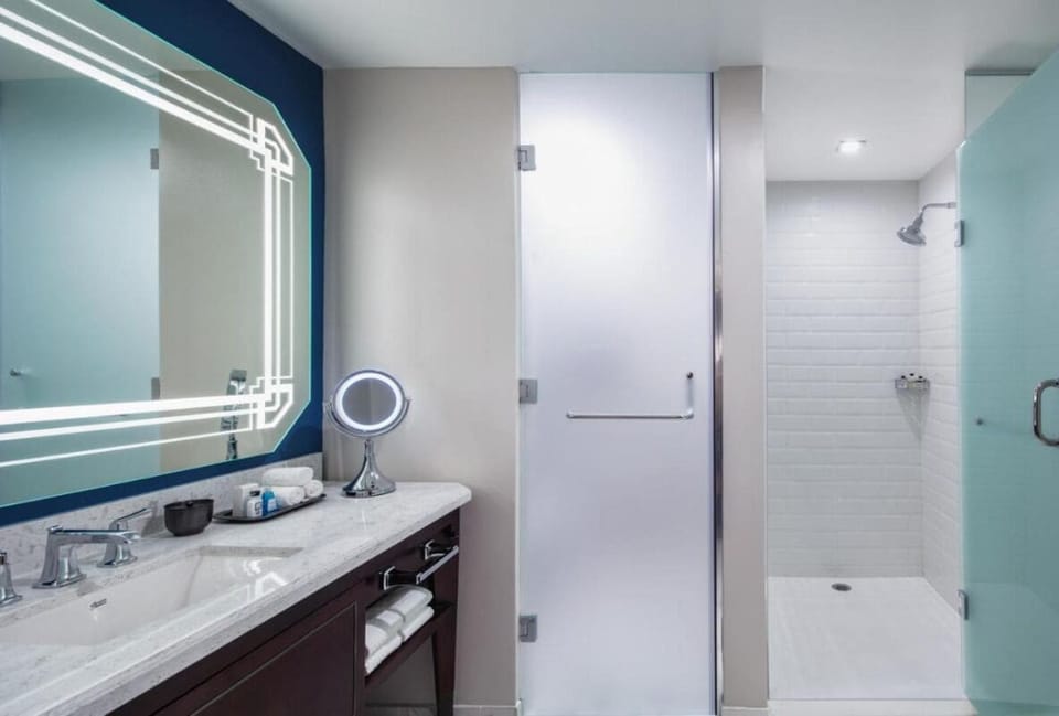 Step into a bright walk-in shower for a spa rinse.
