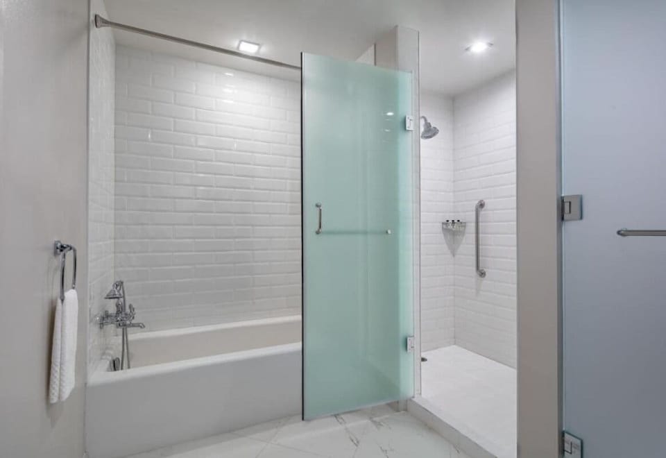 Rinse off in a sleek walk-in shower and tub combo.