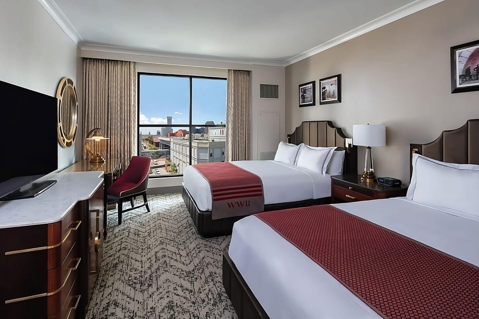 Unwind together in a bright double-queen room with city views.
