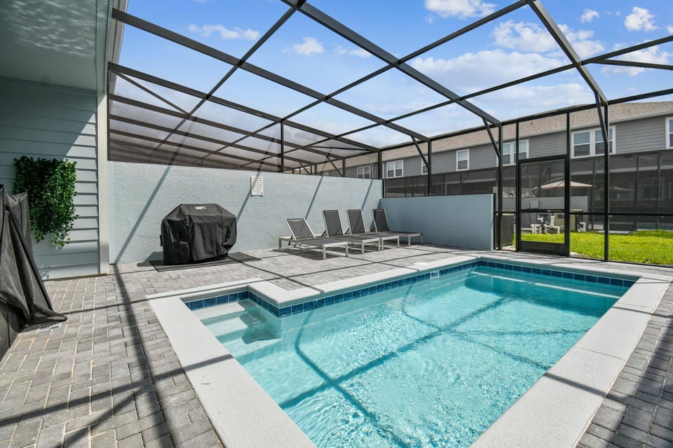 Private screened pool with lounge chairs, perfect for enjoying the Florida sunshine with added comfort and privacy. A relaxing outdoor space for unwinding and spending quality time with family.