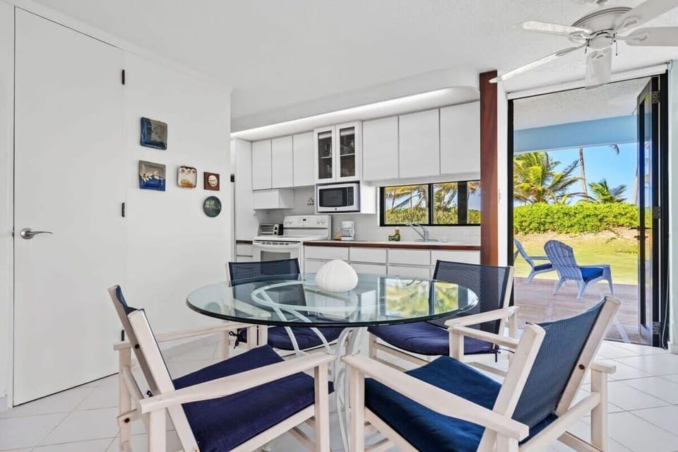 The dining table next to the kitchen. Doors can be opened to let the beach breeze in.
