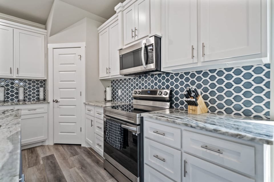 A full kitchen with stainless steel appliances