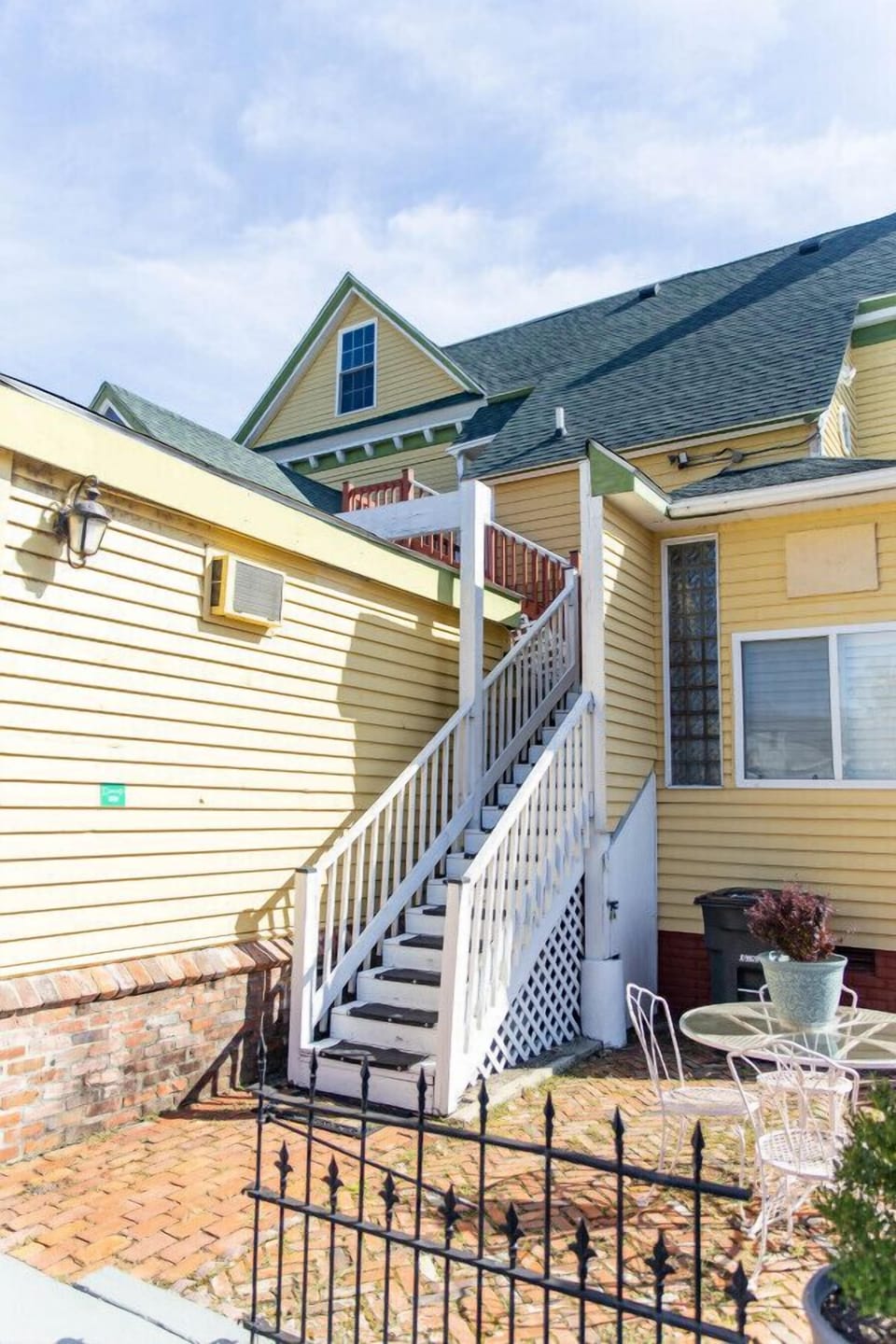 Staircase that you must take to get to this 2nd story apartment. To the right, your private patio.