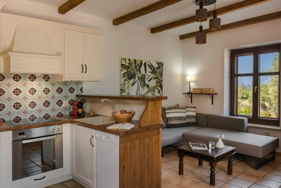Interior Space – Fully Equipped Kitchen – Traditional Cretan kitchen with modern appliances and warm, rustic design.
