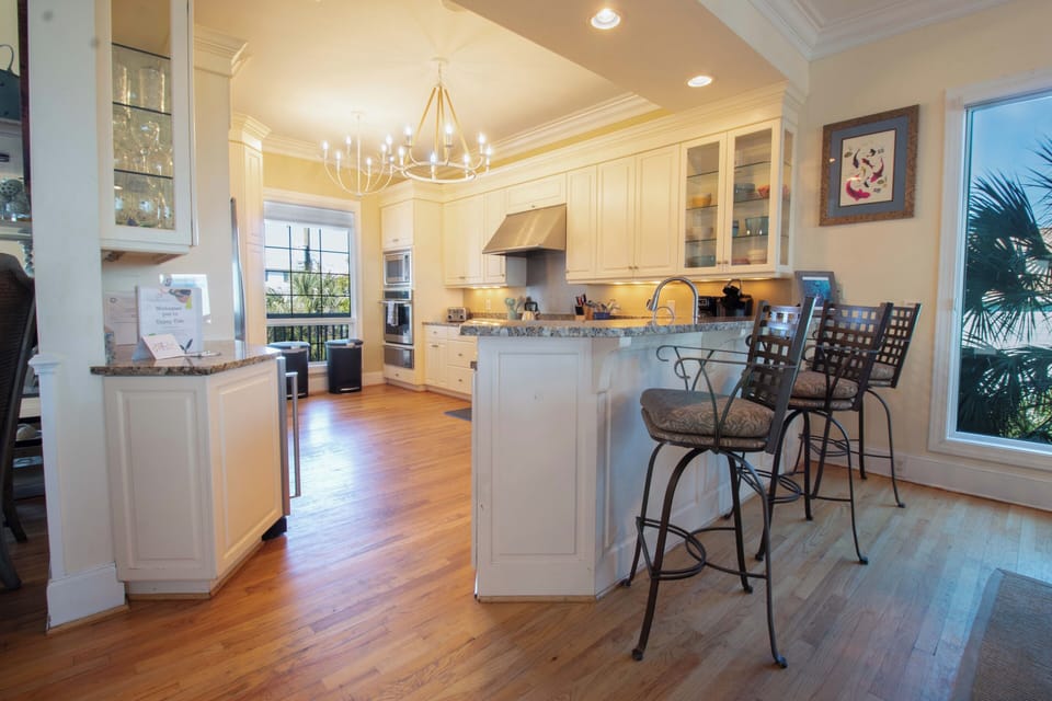 Your gourmet kitchen awaits with gleaming granite counters, premium appliances, and a breakfast bar perfect for morning coffee.