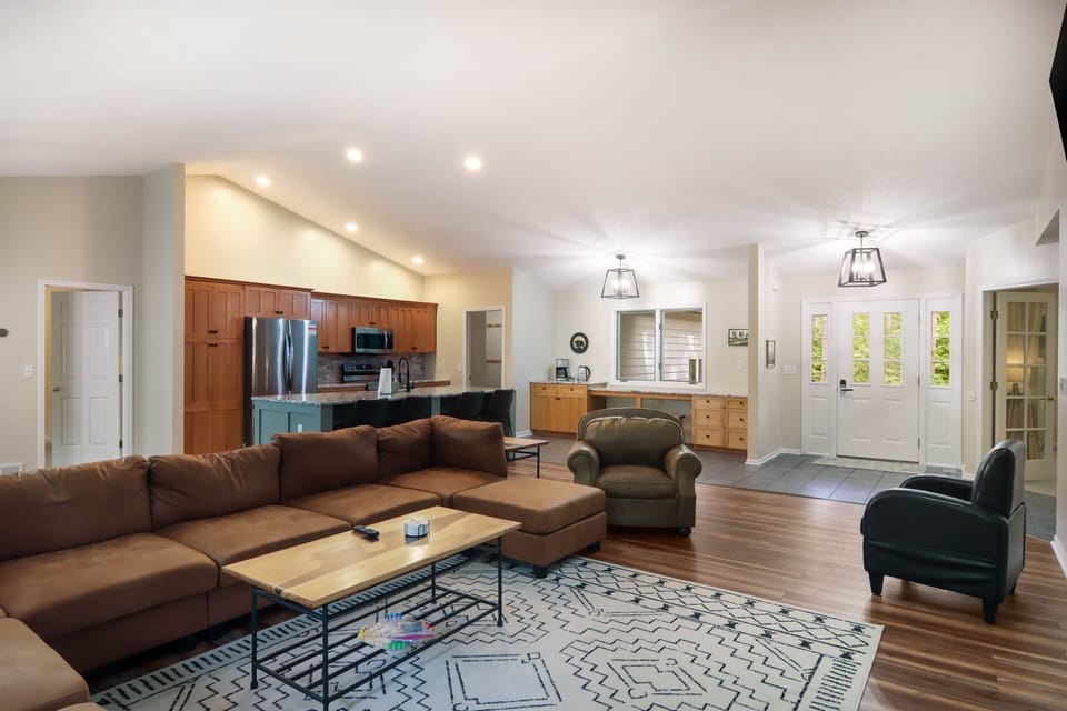 Main floor living room looking at the kitchen and door to the master bedroom
