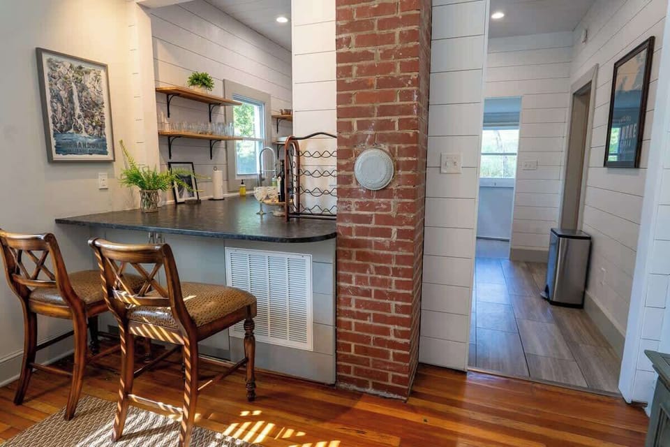 Breakfast area with high stools and brick accent wall