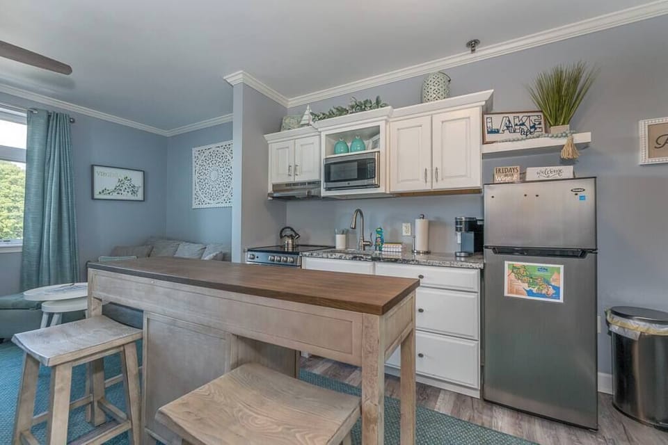 Fully Stocked Kitchen  w/ Breakfast Bar, Refrigerator, Microwave, Oven, Stove, Dishwasher, Coffee Maker, Cooking Utensils and Light Blue Accent Walls