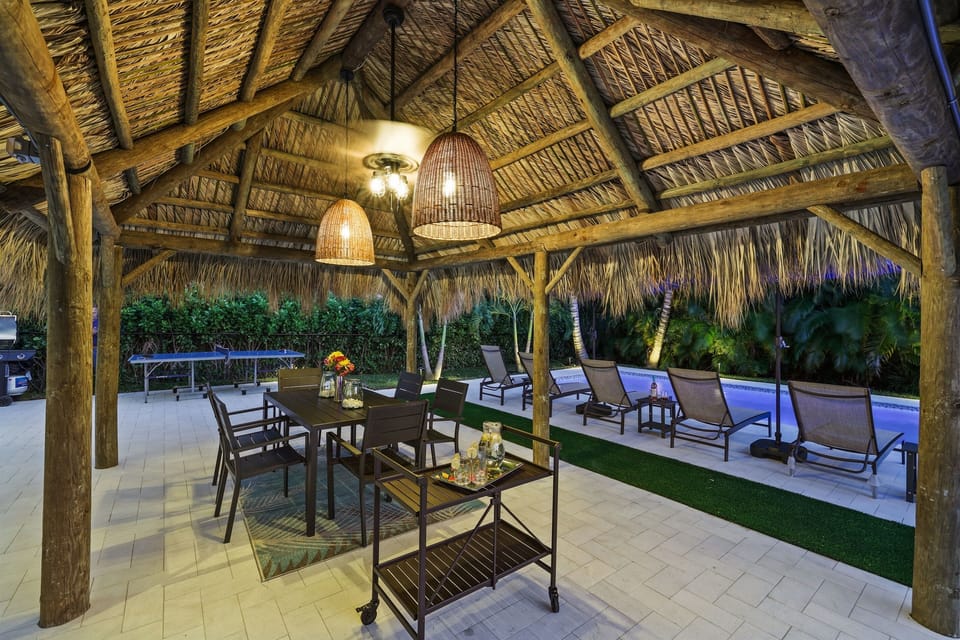 Gather under the lighted Tiki hut for poolside dinners, games, and relaxed evenings in your Delray Beach backyard retreat.
