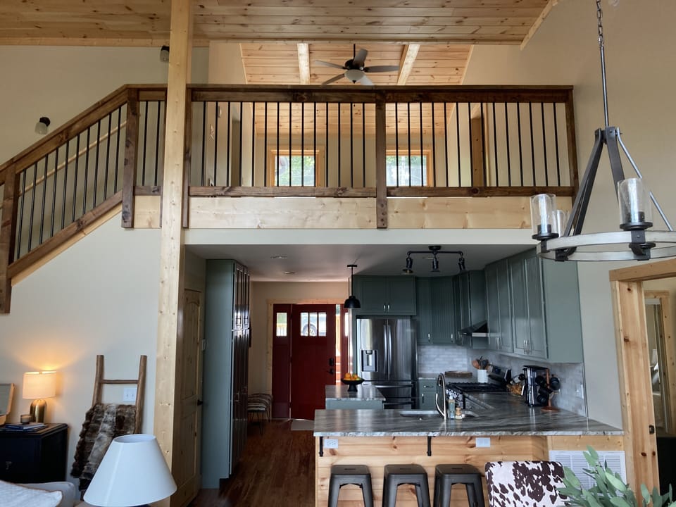 Open-concept living area with vaulted ceilings and cozy loft space.