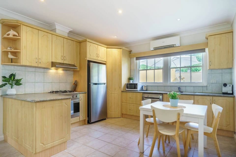 The kitchen comes fully equipped for meals at home and has a dining table where guests can come together.