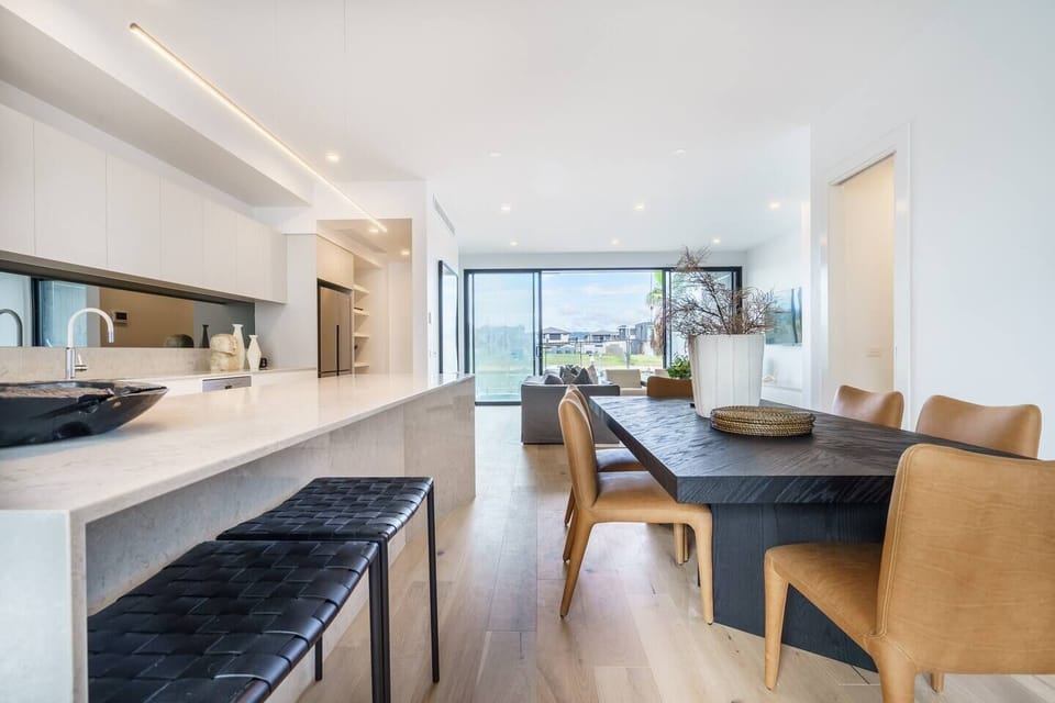 A large dining table encourages shared meals at home, with a gourmet kitchen to cook up a feast.