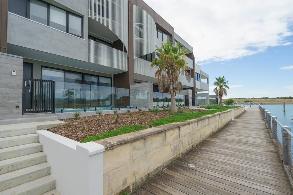 This ultra-modern home enjoys a waterfront location with a pool up front.