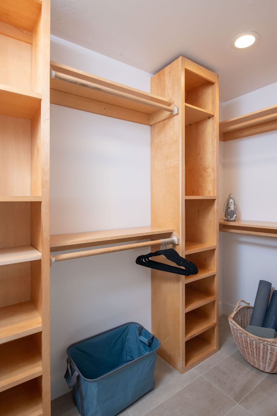 Primary bedroom closet includes yoga mats 