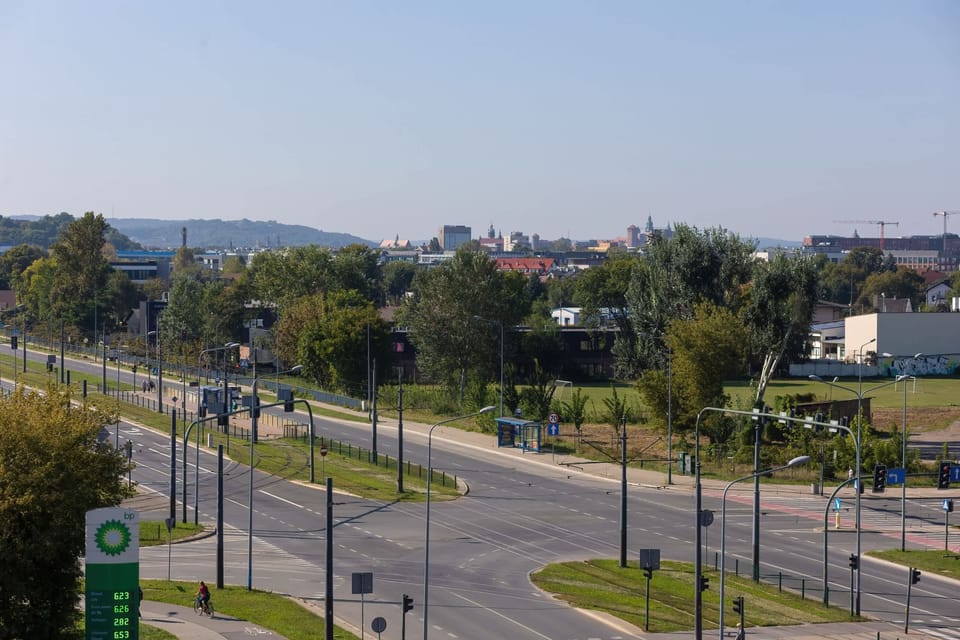 A wide view of the surrounding neighborhood with open roads, greenery, and urban infrastructure.






