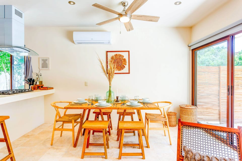 A dining area features a beautiful wood table for 4 to 6 guests