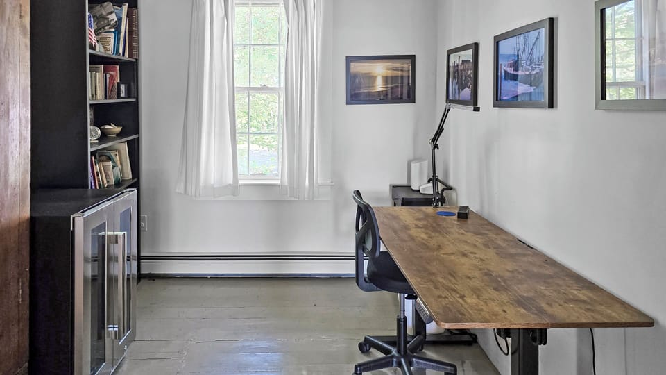 Second floor office area with desk and beverage cooler