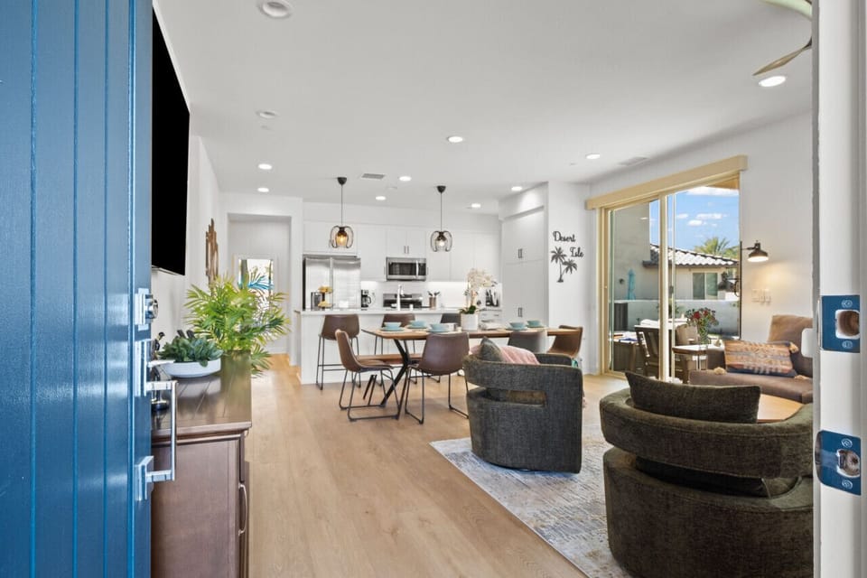 Bright open-concept living area w/ cozy seating & views to the backyard.