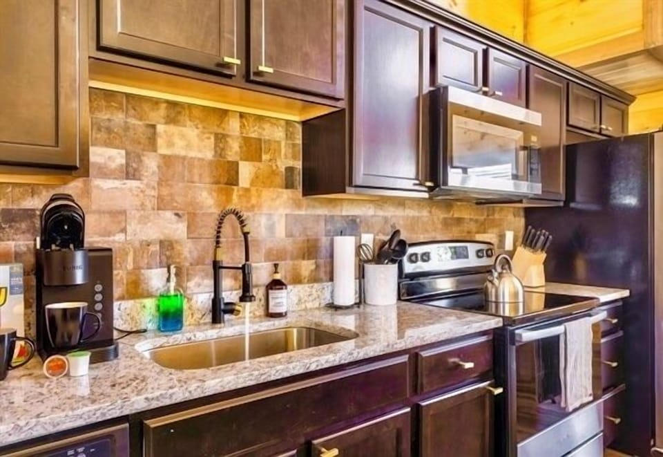 Whip up a hearty breakfast or a homemade feast in this modern kitchen where every pot, pan, and cookware is waiting for your inner chef. The smell of fresh coffee and sizzling bacon fills the air, setting the tone for a day of mountain adventures.