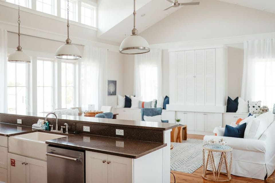 Indoor kitchen/living room. Wall to wall windows on each side. TV behind shutter