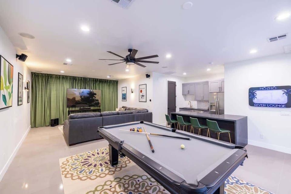 Vibrant game room with retro-inspired wall art and plenty of seating.