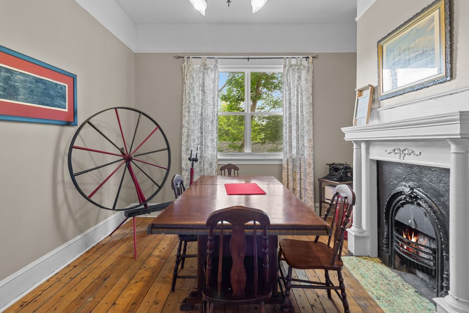 Discover a new perspective on dining sophistication. Our hardwood table steals the spotlight from every angle in this inviting dining room