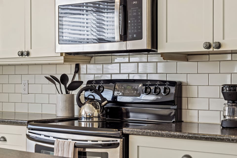Modern kitchen stovetop and cooking essentials for guest convenience