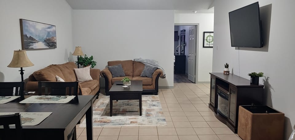 Spacious living room with 55" Smart TV electric fireplace.  There is a sofa bed.