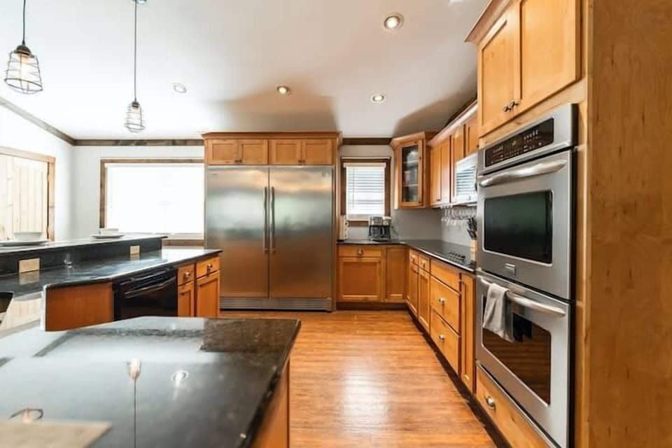 Designed for those who love to cook and entertain, this kitchen features a dual oven setup for seamless meal prep, along with high-end appliances, sleek countertops, and custom cabinetry that blend function and luxury