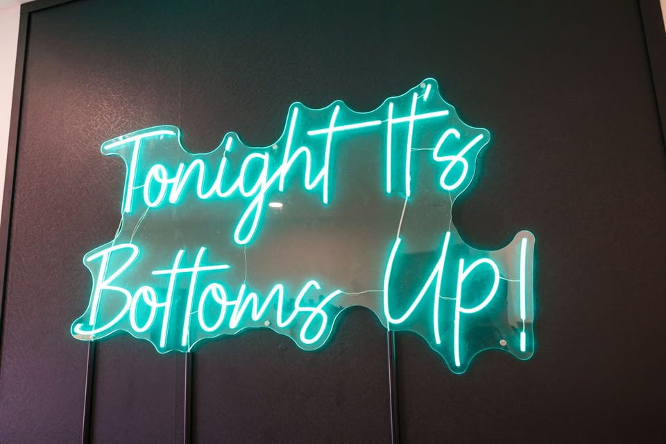 Fully equipped modern kitchen with basic cooking essentials, stainless steel appliances, island bar seating, Keurig coffee machine, and wet bar.