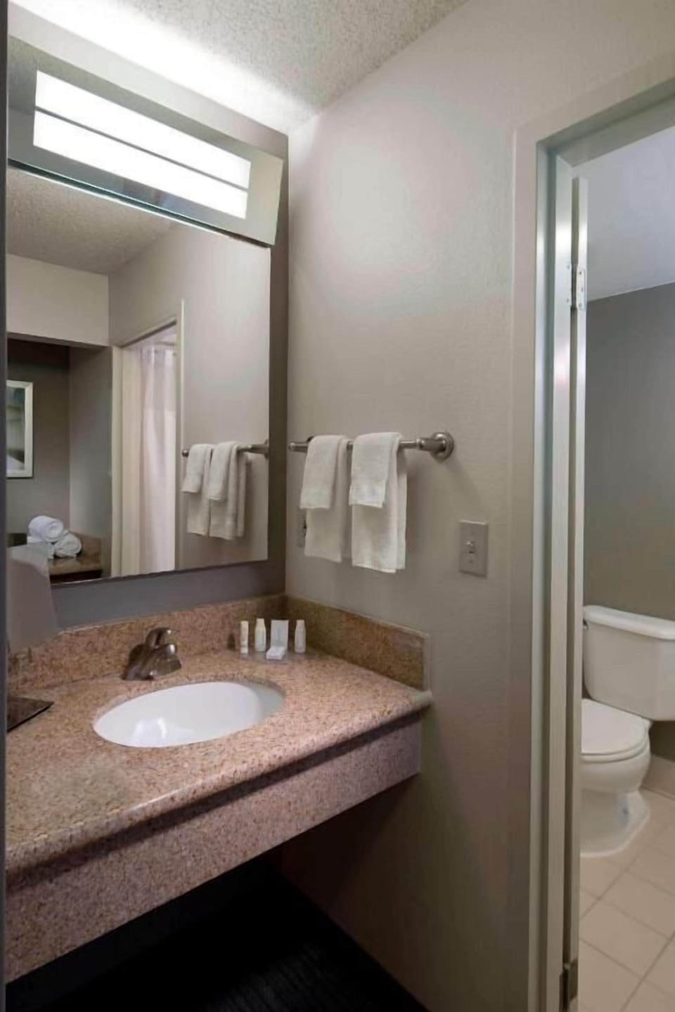 Freshen up at the granite vanity with plush towels.