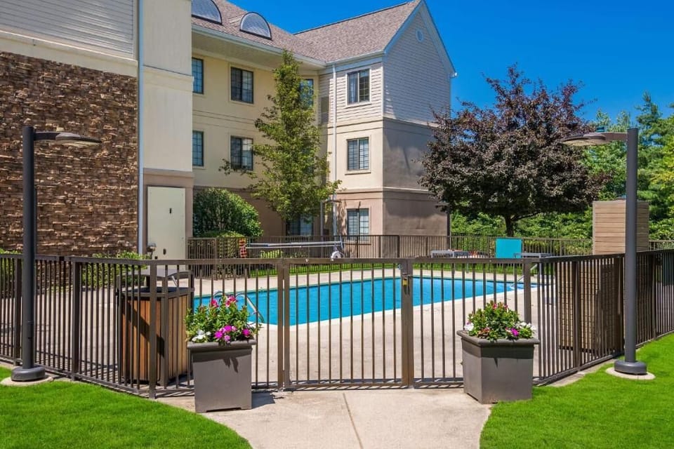 Dive into sunny pool days in a peaceful courtyard.