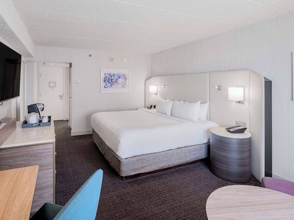 Relax in a modern king room with clean, calming design.