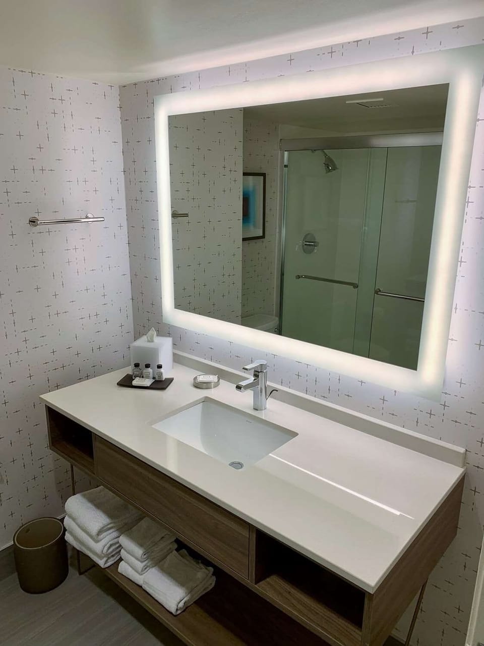 Start your morning at a glowing mirror and spacious vanity.