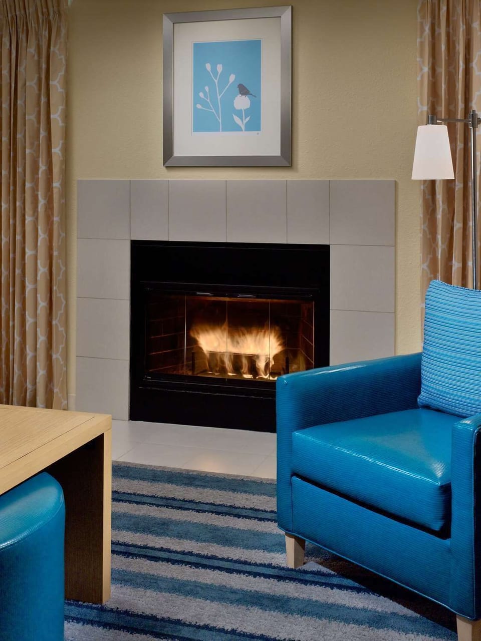 Cozy up by the glowing fireplace after a full day out.